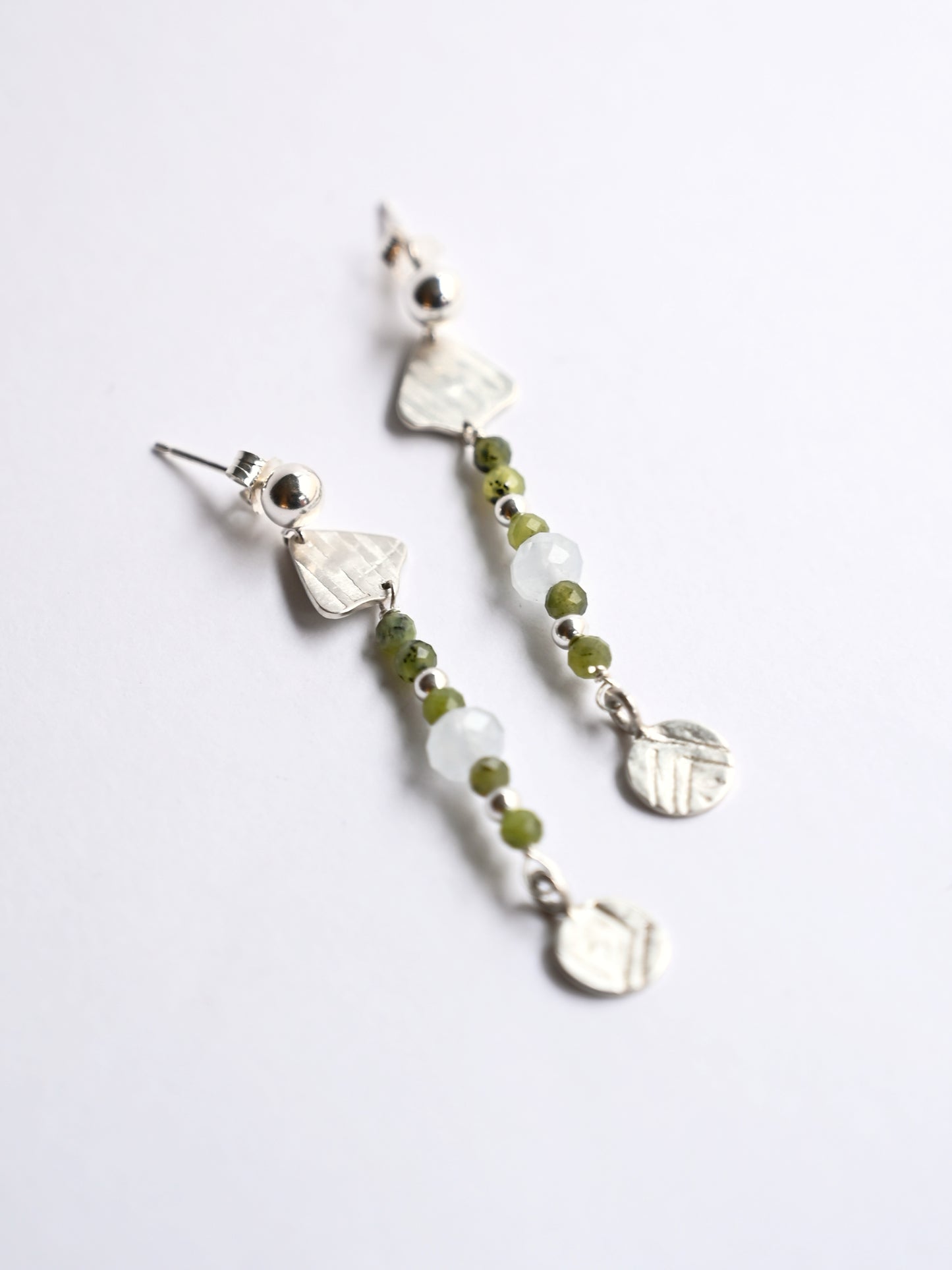 Silver dangling earrings with jade & aquamarine on white background