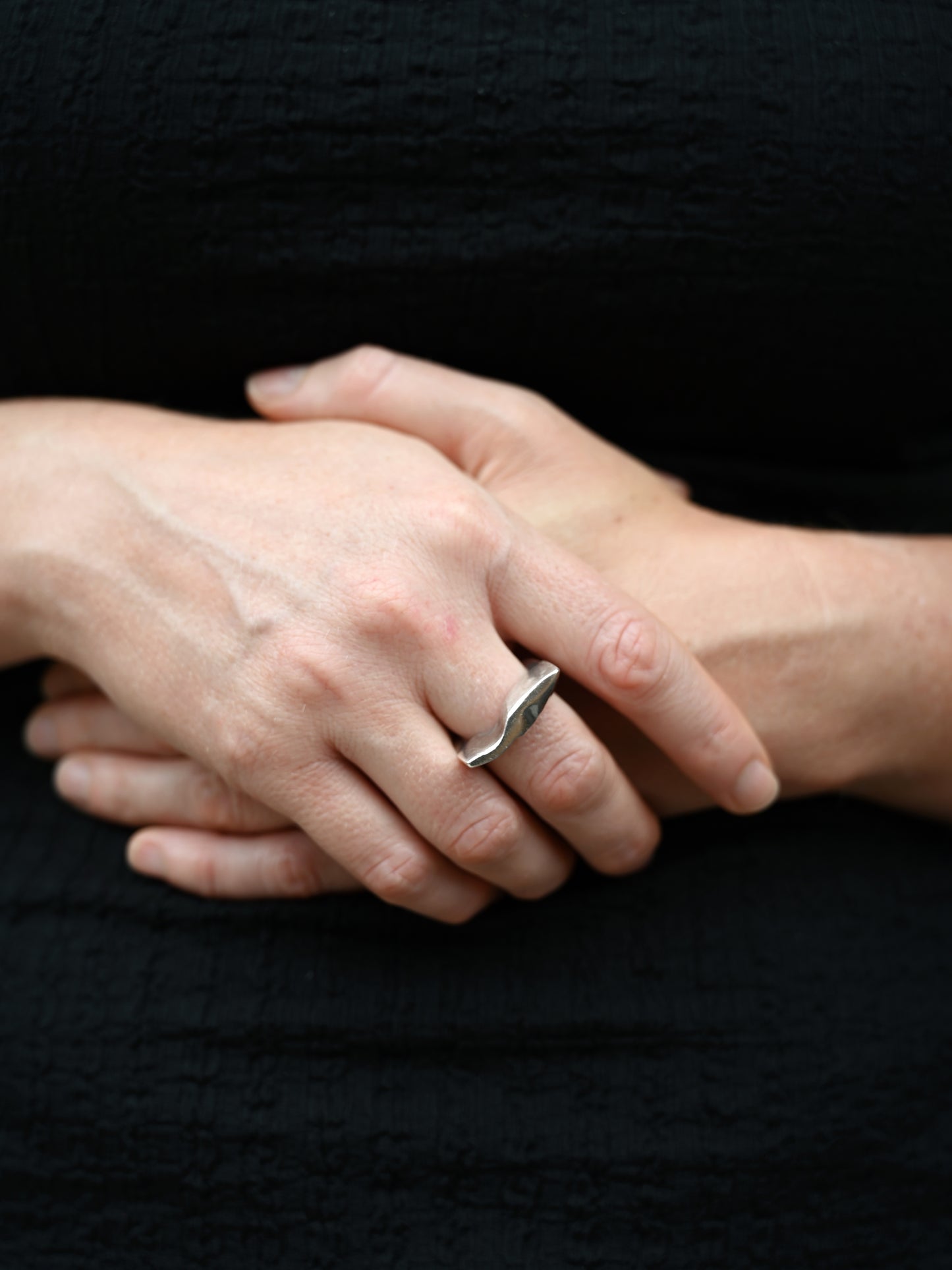 vignette sculptural ring on middle finger hand over hand