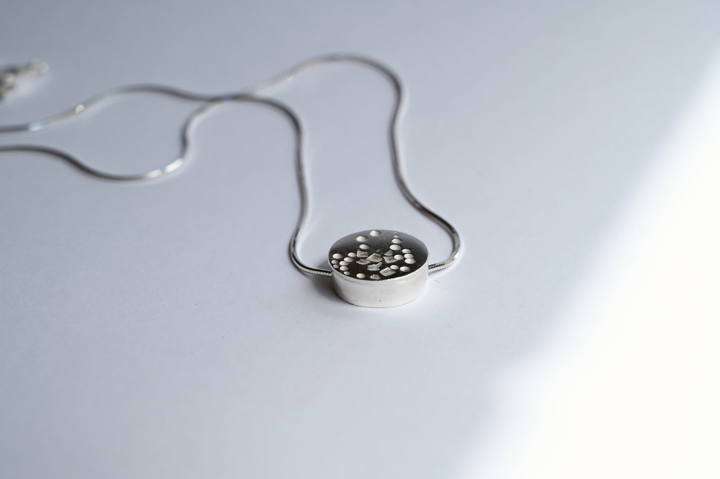 one circle small necklace laying flat on a white background