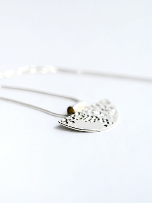 Silver half tube contrast pendant on white background