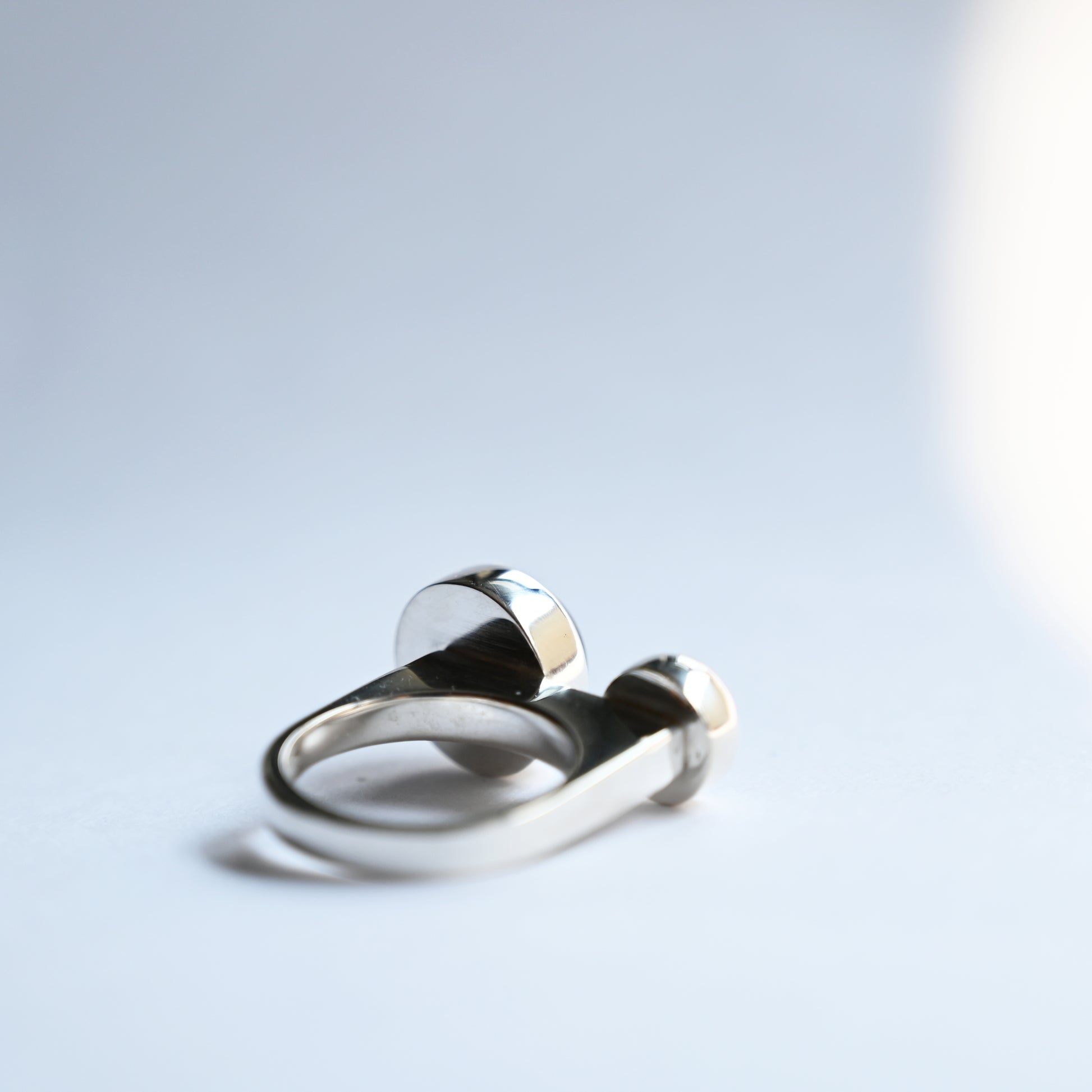 Component ring with double abalone stones, back view of ring on white background