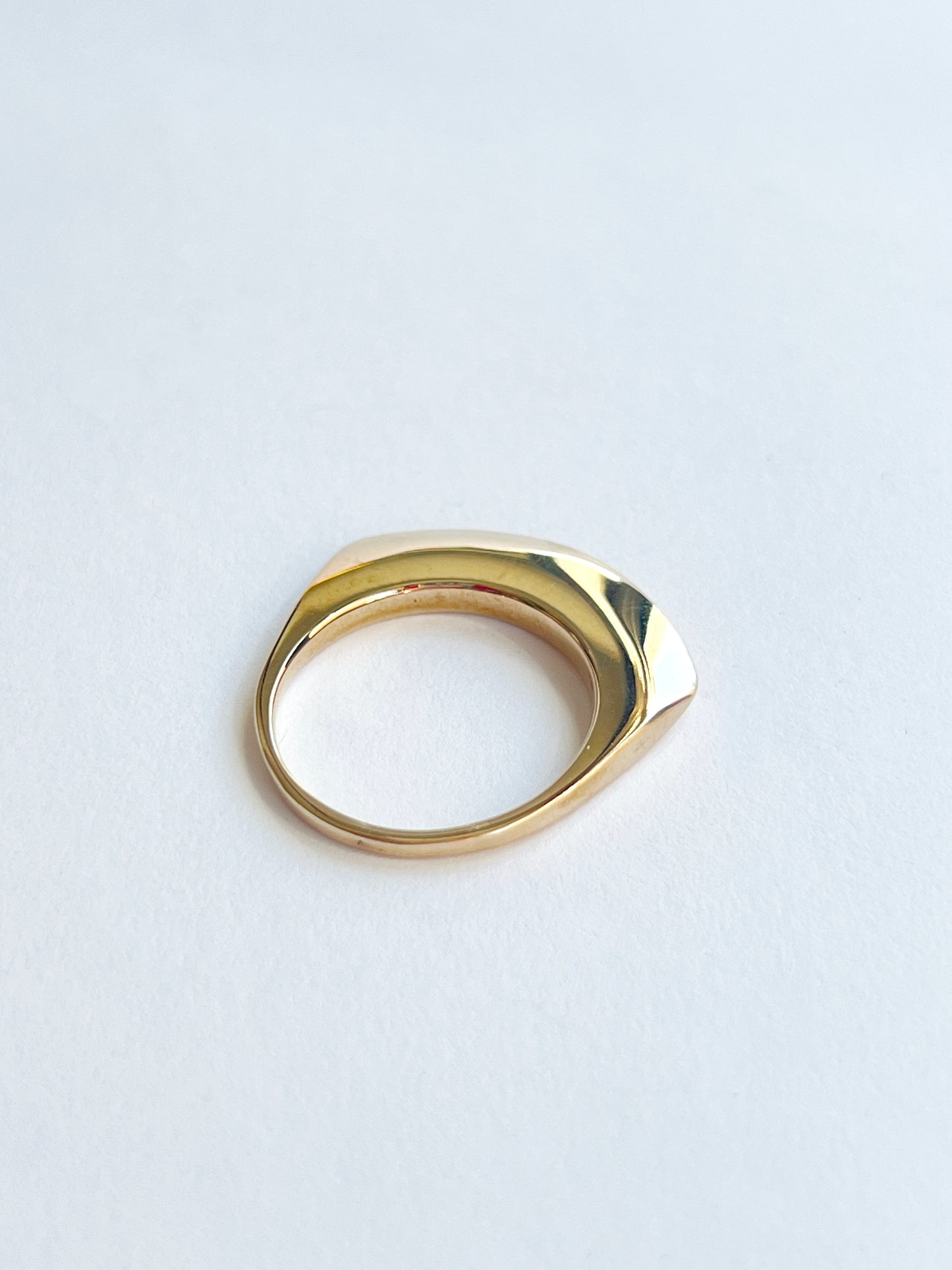 back angle of bronze ring on a white background