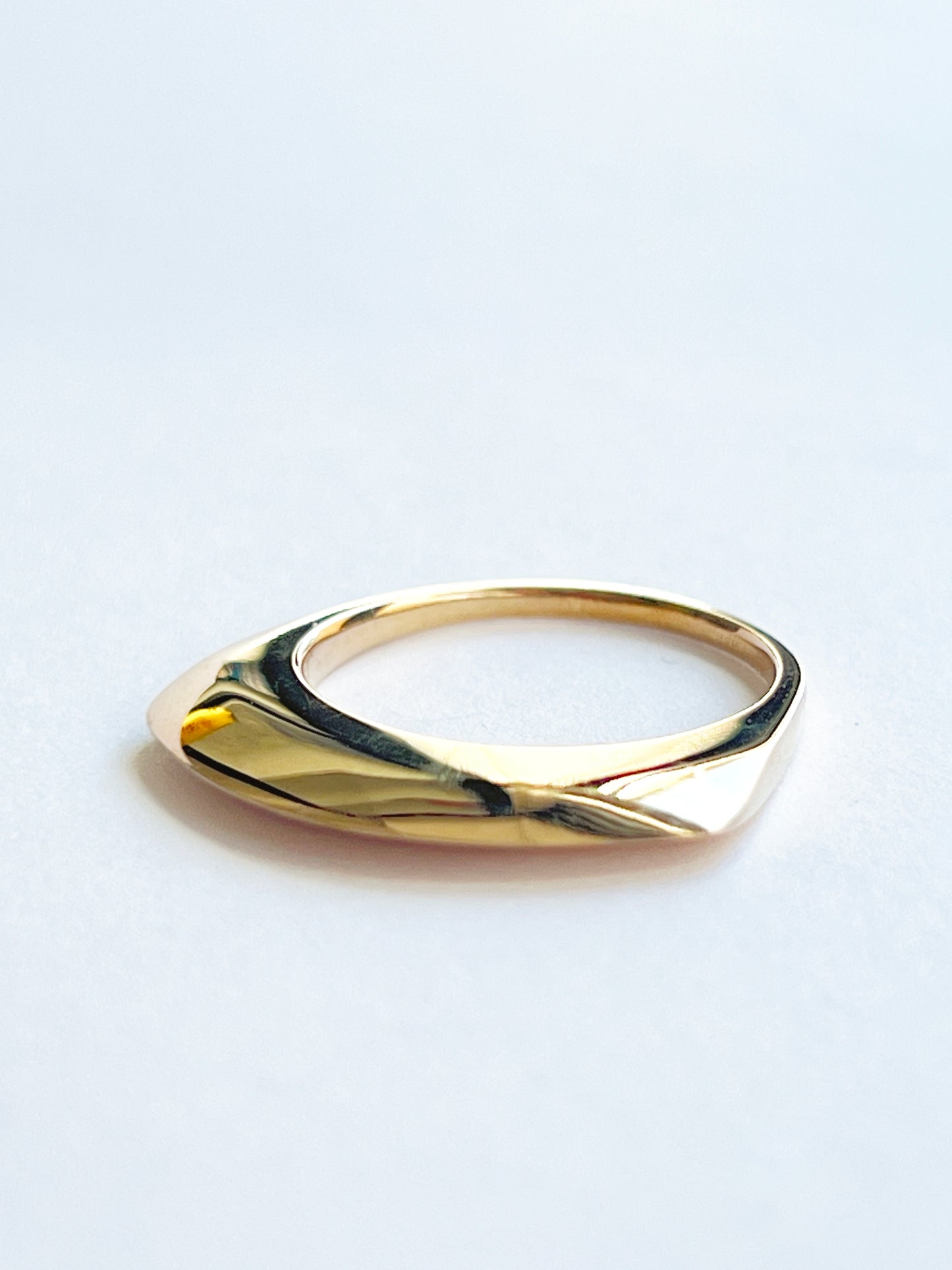 bronze ring laying flat on a white background